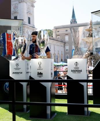 Fans pose for photos in the Super Cup fanzone next to the Super Cup, Champions League and Europa League trophies. Paris St Germain v Aston Villa, UEFA Super Cup Final, Football, Red Bull Arena, Salzburg, Austria - 12 Aug 2026Salzburg Red Bull Arena, Austria  Copyright: xJamesxMarsh Shutterstockx 17064758q