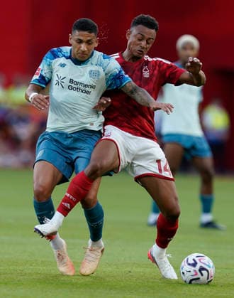 Nottingham, England, 12th August 2026. Equi Fernandez of Bayer Leverkusen (L) challenges Dan Ndoye of Nottingham Forest during the Nottingham Forest vs Bayer Leverkusen Pre Season Friendly match at the City Ground, Nottingham. Picture credit should read: Andrew Yates Sportimage EDITORIAL USE ONLY. No use with unauthorised audio, video, data, fixture lists, club league logos or live services. Online in-match use limited to 120 images, no video emulation. No use in betting, games or single club league player publications. SPI_001_AY_NOTTS_FOREST_LEVERKUSEN SPI-4901-0001