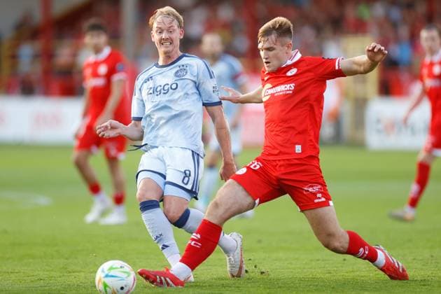DUBLIN , 13-08-2026, Tolka Park Stadium , season 2026 2027 , UEFA Conference League play-off football . Match between Shelbourne FC and Ajax, Picture shows Ajax player Julian Brandt and Shelbourne player Odhran Casey Shelbourne - Ajax  x205681660x Copyright: