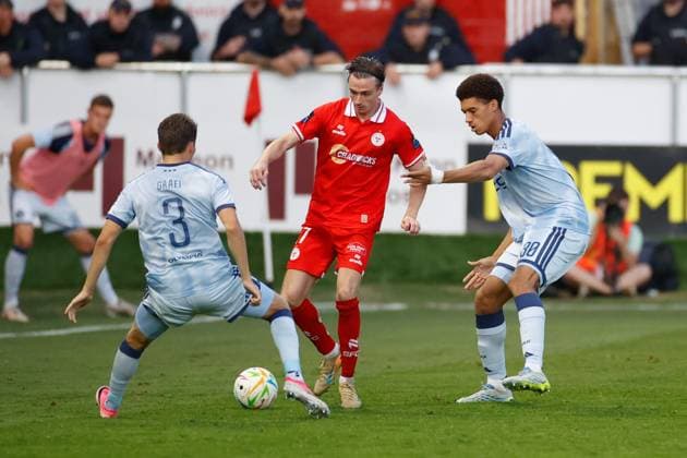 DUBLIN , 13-08-2026, Tolka Park Stadium , season 2026 2027 , UEFA Conference League play-off football . Match between Shelbourne FC and Ajax, Picture shows Ajax player Anton Gaaei , Shelbourne player Daniel Kelly and Ajax player Aaron Bouwman Shelbourne - Ajax  x205683004x Copyright: