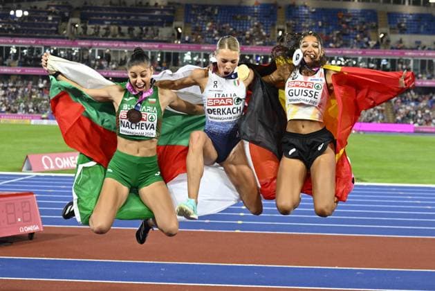Bulgarian Aleksandra NACHEVA, winner of the bronze medal, Italian Dariya DERKACH, winner of the gold medal, Belgian Saliyya GUISSE, winner of the silver medal, pictured with their flags after the final of the women s triple jump event on the fourth day of the European Athletics Championships (August 10-18) in Birmingham, United Kingdom, on Thursday 13 August 2026. ERICxLALMAND  x183322684x