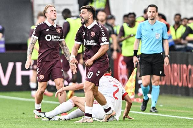 Heart of Midlothian v Benfica UEFA Europa League Calvin Miller and Claudio Braga of Heart of Midlothian reacts after Claudio Braga is shown a yellow card after he fouls Clement Lenglet of Benfica during the UEFA Europa League Third Qualifying Round Second Leg match at Tynecastle Park, Edinburgh 13 08 2026 UK Newspapers OUT Copyright: xJamiexJohnstonx FIL-23768-0176