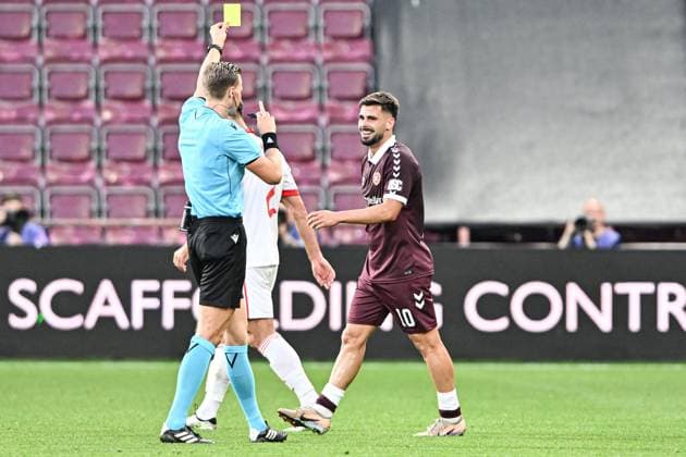 Heart of Midlothian v Benfica UEFA Europa League Claudio Braga of Heart of Midlothian is shown a yellow card by the match referee Sander van der Eijk during the UEFA Europa League Third Qualifying Round Second Leg match at Tynecastle Park, Edinburgh 13 08 2026 UK Newspapers OUT Copyright: xJamiexJohnstonx FIL-23768-0177