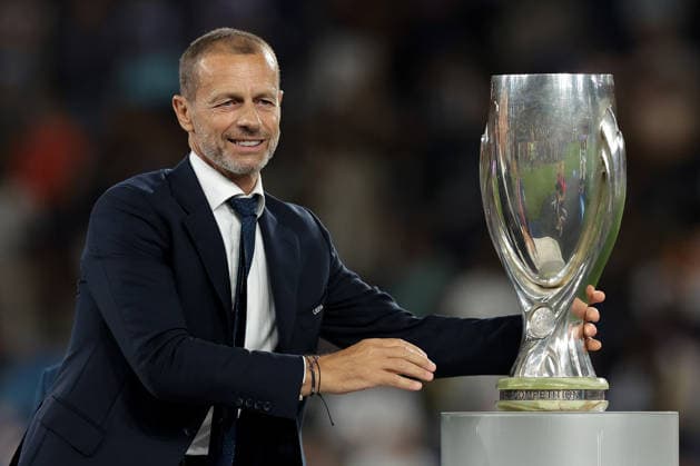 Paris Saint Germain v Aston Villa - UEFA Super Cup - Stadion Salzburg Salzburg, Austria, 12th August 2026. UEFA President Aleksander Ceferin reaches for the UEFA Supercup to present to Marquinhos of PSG following the Paris Saint Germain vs Aston Villa UEFA Super Cup match at Stadion Salzburg, Salzburg. Picture credit should read: Jonathan Moscrop Salzburg Stadion Salzburg Austria