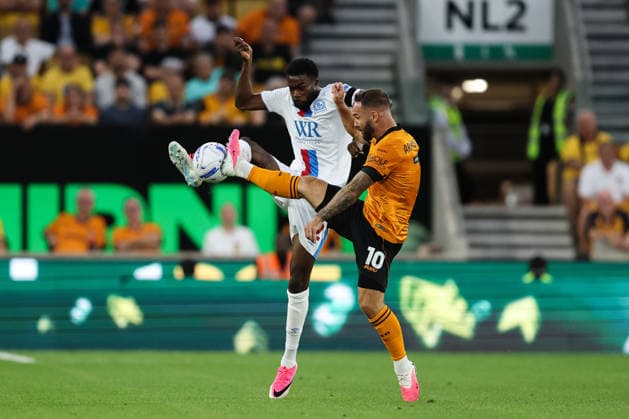 Wolverhampton, England, 14th August 2026. Ryan Alebiosu of Blackburn Rovers and Adam Armstrong of Wolverhampton Wanderers battle for the ball during the Wolverhampton Wanderers vs Blackburn Rovers Sky Bet Championship match at Molineux, Wolverhampton. Picture credit should read: Gareth Evans Sportimage EDITORIAL USE ONLY. No use with unauthorised audio, video, data, fixture lists, club league logos or live services. Online in-match use limited to 120 images, no video emulation. No use in betting, games or single club league player publications. SPI_045_GE_WOL_vs_BBR SPI-4907-0044