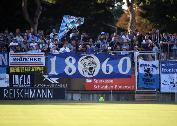 Fussball, Herren, Regionalliga Bayern, Saison 2026 2027, FC Memmingen - TSV 1860 München , e-con Arena Park im Memminger Stadion Hier die Fans des TSV 1860 München in ihrer Fankurve, Stimmung, Banner, Fahne *** Soccer, Men s, Bavarian Regional League, 2026–2027 Season, FC Memmingen vs. TSV 1860 Munich, at Arena Park in Memmingen Stadium. Here are the TSV 1860 Munich fans in their fan section, with a lively atmosphere, banners, and flags.