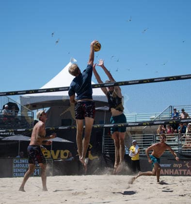 August 14, 2026, Manhattan Beach, California, USA: JACOB LABOUILERE spikes a ball as ANDY BENESH leaps for the block during their second round match at the Manhattan Beach Open. Manhattan Beach USA - ZUMAl183 20260814_znp_l183_024 Copyright: xJasenxLaksx