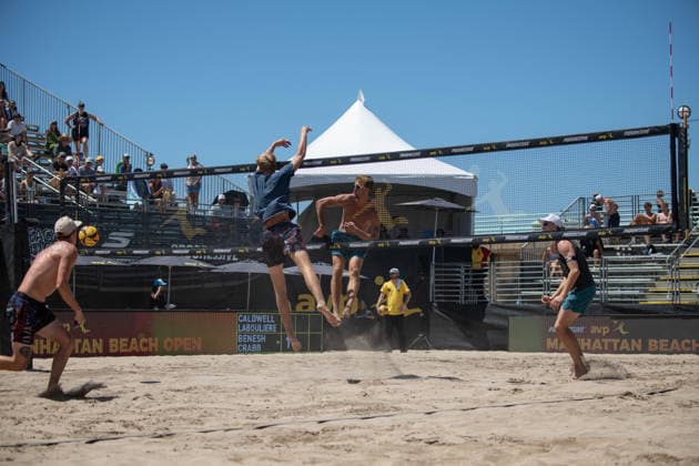 August 14, 2026, Manhattan Beach, California, USA: TAYLOR CRABB (center) spikes a ball over the net as JACOB LABOULIERE attempts the block in their second round match at the Manhattan Beach Open. Manhattan Beach USA - ZUMAl183 20260814_znp_l183_030 Copyright: xJasenxLaksx
