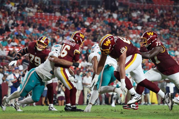 August 14, 2026, Landover, Maryland, USA: Miami Dolphins defensive tackle Alex Huntley (96) tackles Washington Commanders quarterback Athan Kaliakmanis (16) during the NFL, American Football Herren, USA preseason game between the Washington Commanders and Miami Dolphins at Northwest Stadium on Friday, August 14, 2026; Landover, Maryland, USA. Landover USA - ZUMAs325 20260814_zsp_s325_110 Copyright: xJessxStilesx