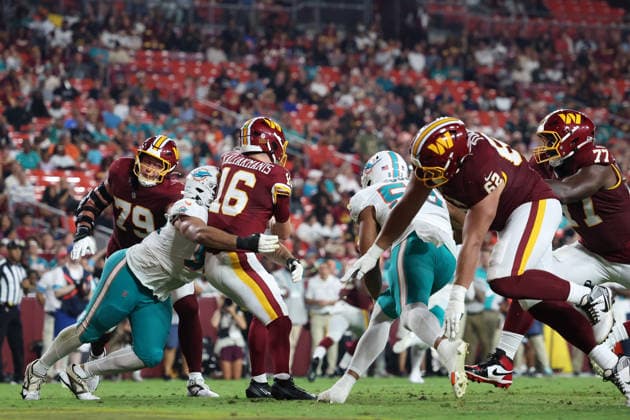 August 14, 2026, Landover, Maryland, USA: Miami Dolphins defensive tackle Alex Huntley (96) tackles Washington Commanders quarterback Athan Kaliakmanis (16) during the NFL, American Football Herren, USA preseason game between the Washington Commanders and Miami Dolphins at Northwest Stadium on Friday, August 14, 2026; Landover, Maryland, USA. Landover USA - ZUMAs325 20260814_zsp_s325_127 Copyright: xJessxStilesx