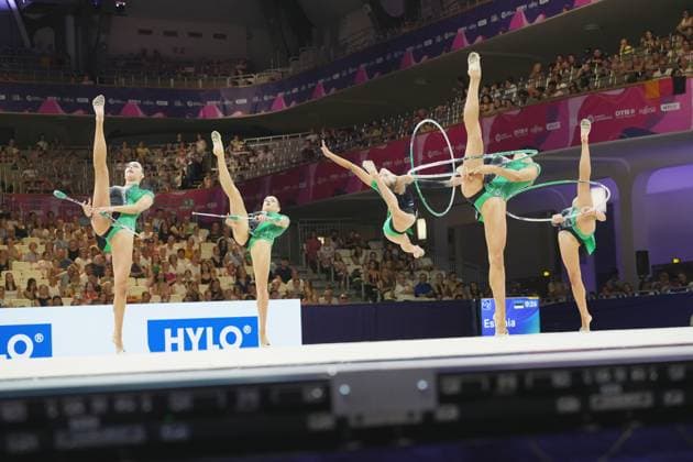 Das estnische Gruppenteam zeigt eine synchronisierte Gruppenübung mit Reifen und Keulen bei der Weltmeisterschaft der Rhythmischen Sportgymnastik 2026 in der Festhalle Frankfurt. Vier Turnerinnen in grün-schwarzen Trikots führen gleichzeitig hohe Beinstreckungen aus, während sie die Geräte in der Luft halten. Estlands Gruppenteam mit Reifen und Keulen bei der Rhythmischen Sportgymnastik-WM *** The Estonian group team performs a synchronized group routine with hoops and clubs at the 2026 Rhythmic Gymnastics World Championships in Frankfurt’s Festhalle. Four gymnasts in green and black leotards simultaneously perform high leg extensions, while holding the apparatus in the air. Estonia’s group team with hoops and clubs at the Rhythmic Gymnastics World Championships Copyright: xspeedshotx