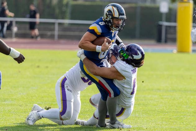 Hank Bachmeier (Alpine Rams, 8) carries the football while driving forward through contact as Vienna Vikings defenders wrap him up.. Vienna Vikings at Alpine Rams, American Football, American Football League Europe, Week 13, 2026, 8.8.2026, Copyright: xPFA RicoxDoninellix