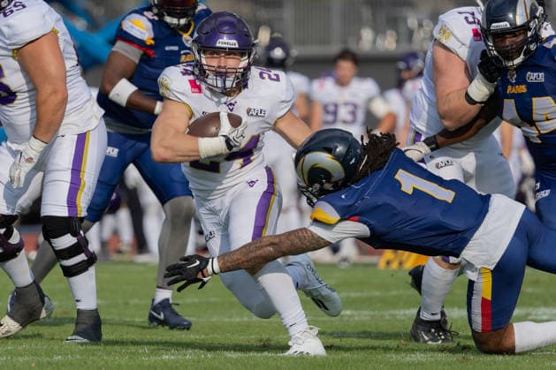Vienna Vikings player Karri Pajarinen ( 24) carries the football while driving forward through contact as Alpine Rams defender Cameron Bergeron ( 1) attempts to tackle him from the ground during live game action.. Vienna Vikings at Alpine Rams, American Football, American Football League Europe, Week 13, 2026, 8.8.2026, Copyright: xPFA RicoxDoninellix