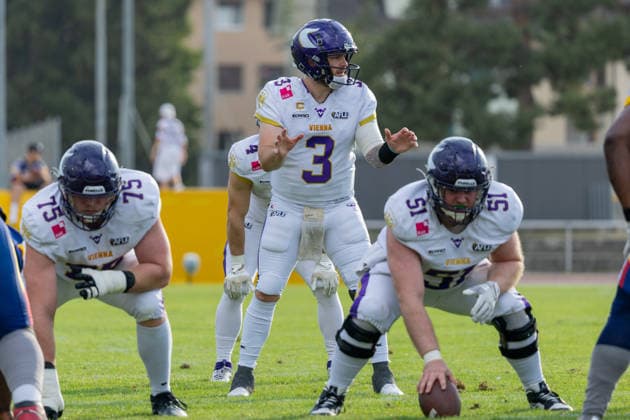 Vienna Vikings player Ben Holmes ( 3) signals to teammates at the line of scrimmage. Teammates Clemens Walz ( 51) and Felix Lepper ( 73) line up in three-point stances. Vienna Vikings at Alpine Rams, American Football, American Football League Europe, Week 13, 2026, 8.8.2026, Copyright: xPFA RicoxDoninellix