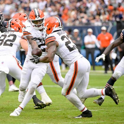 Cleveland Browns quarterback Shedeur Sanders (2) hands off the ball to Cleveland Browns running back Ahmani Marshall (23) in the third quarter against the Chicago Bears during a preseason game at Soldier Field in Chicago on Saturday, August 15, 2026. The Bears defeated the Brown 34-10.  CHI20260815131 MARKxBLACK