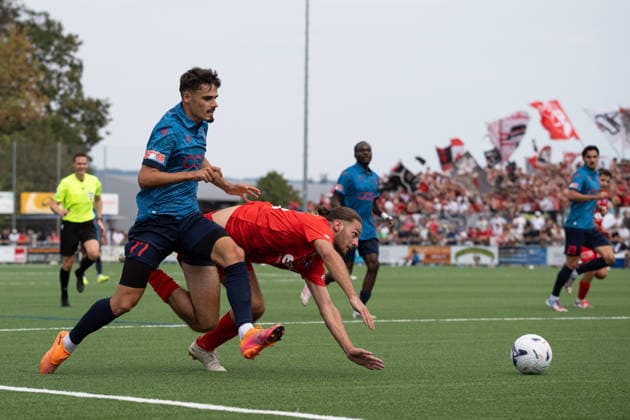 KERZERS, FRIBOURG, SWITZERLAND - AUGUST 16: Donat Rudhani of FC Sion holds back Enea Rostetter of FC Kerzers during the Swiss Cup first round match between FC Kerzers and FC Sion at Stadion Erli on August 16, 2026 in Kerzers, Fribourg, Switzerland.  Copyright: xLivioxBaeriswylx xSPPx Sportspressphoto_SPR208873