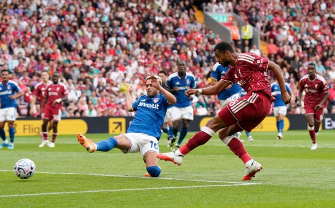 Liverpool, England, 16th August 2026. Cody Gakpo of Liverpool (R) scores the opening goal during the Liverpool vs Como 1907 Pre Season Friendly match at Anfield, Liverpool. Picture credit should read: Andrew Yates Sportimage EDITORIAL USE ONLY. No use with unauthorised audio, video, data, fixture lists, club league logos or live services. Online in-match use limited to 120 images, no video emulation. No use in betting, games or single club league player publications. SPI_001_AY_LIVERPOOL_COMO SPI-4910-0001
