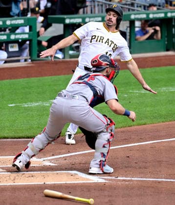 Pittsburgh Pirates left fielder Bryan Reynolds (10) slides into home ahead of the throw to Boston Red Sox catcher Connor Wong (12) in the first inning against the Boston Red Sox at PNC Park on Sunday, Aug. 16, 2026 in Pittsburgh.  PIT2026081611 ArchiexCarpenter
