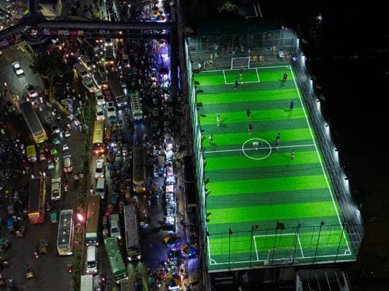 Rooftop Football In A Crowded Megacity People play football on an artificial rooftop field atop an 11-story building, surrounded by dense buildings, busy streets and heavy traffic in Dhaka, Bangladesh, on August 18, 2026. Dhaka Bangladesh  Copyright: xBipulxAhmedx originalFilename:mondol-notitle260818_npzjC.jpg