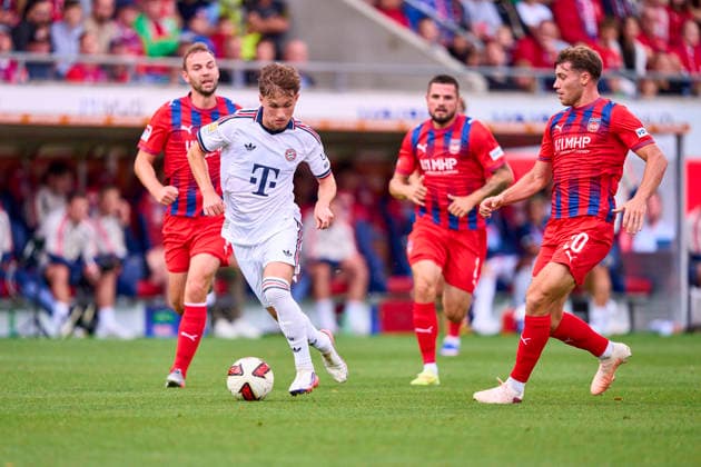 Tim Binder of FC Bayern München compete for the ball, tackling, duel, header, zweikampf, action, fight against Luca Kerber of Heidenheim Benedikt Gimber of Heidenheim Marnon Busch of Heidenheim at the friendly match 1.FC Heidenheim - FC Bayern München on August 18, 2026 in Heidenheim, Germany Season 2026 2027, FCB,
