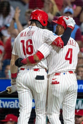 Philadelphia Phillies Brandon Marsh (16) congratulates Luis Arraez (4) after he scored on a two run RBI by Bryson Stott during the sixth inning of a baseball game against the Miami Marlins, Tuesday, Aug. 18, 2026, in Philadelphia, Pennsylvania.  PHI20260818016 LaurencexKesterson