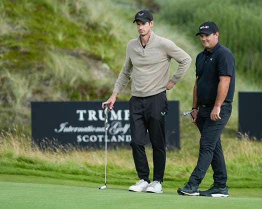 BALMEDIE, SCOTLAND - AUG 19: Andy Murray, former Tennis player speaks with Patrick Reed (USA) on the first green during the Pro-Am at the 2026 Nexo Championship at the Trump International Golf Links, Balmedie on August 19, 2026 in Aberdeenshire, Scotland The 2026 Nexo Championship