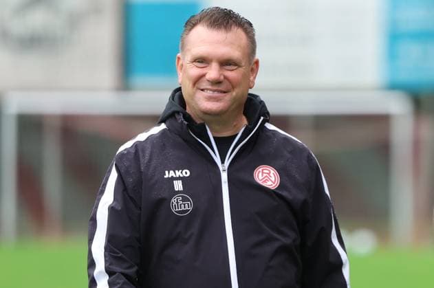 Uwe Koschinat, Trainer von Rot-Weiss Essen, steht lächelnd vor dem Willi-Lemkens Sportpark in Sonsbeck. Er trägt eine schwarze JAKO-Trainingsjacke mit dem RWE-Vereinsemblem und den Initialen UK. Uwe Koschinat (Trainer, Rot-Weiss Essen) lächelt vor dem Spiel *** Uwe Koschinat, coach of Rot Weiss Essen, stands smiling in front of the Willi Lemkens Sportpark in Sonsbeck. He is wearing a black JAKO tracksuit jacket with the RWE club emblem and the initials UK. Uwe Koschinat, coach of Rot Weiss Essen, smiles before the game. Copyright: xspeedshotx xTimoxBluhmki-Schmidtx