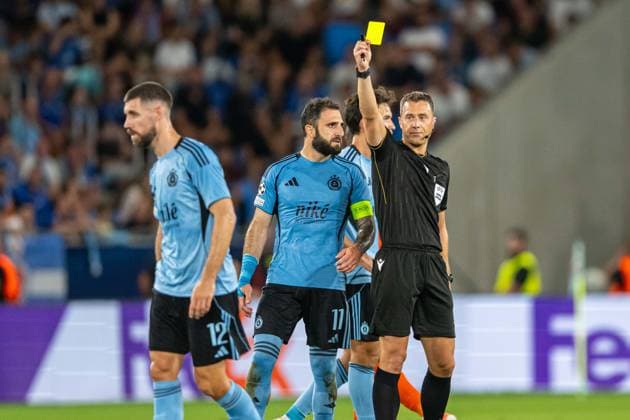 Referee shows a yellow card to Kenan Bajric during Champions League qualifying playoff match, SK Slovan Bratislava - NK Celje , 19. august 2026, Tehelne pole Stadium, Bratislava, Slovakia Copyright: xMICHALxFAJT,ZOSPORTU.SKx MAR_8309