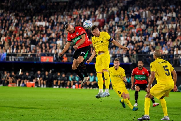 NIJMEGEN, NETHERLANDS - AUGUST 19: Bryan Linssen of NEC Nijmegen and Odin Bjortuft of FK Bodo Glimt compete for the headed ball during the UEFA Champions League 2026 27 play-offs first leg match between N.E.C. Nijmegen and FK Bodo Glimt at Goffertstadion on August 19, 2026 in Nijmegen, Netherlands.  Copyright: xRenexNijhuis MBxMediax