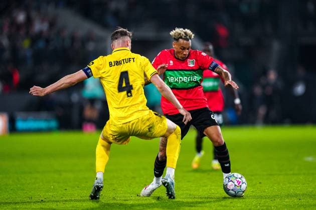 NIJMEGEN , 19-08-2026 , Stadium De Goffert , season 2026 2027 , UEFA Champions League play-offs 1st leg football , match between NEC Nijmegen and Bodo Glimt , picture shows Bodo Glimt player Odin Bjortuft and NEC player Tjaronn Chery NEC - Bodo Glimt  x205855656x Copyright: