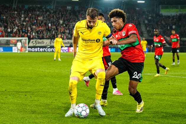 2026-08-19 NEC Nijmegen v Bodo Glimt - UEFA Champions League Play-offs - 1st leg NIJMEGEN, NETHERLANDS - AUGUST 19: Odin Bjortuft of FK Bodo Glimt, Noe Lebreton of N.E.C. Nijmegen during the UEFA Champions League Play-offs - 1st leg match between NEC Nijmegen and Bodo Glimt at Goffertstadion on August 19, 2026 in Nijmegen, Netherlands. Nijmegen Goffertstadion Netherlands Content not available for redistribution in The Netherlands directly or indirectly through any third parties. Copyright: xAndrexWeeningx