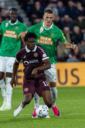 SOCCER - UEFA ECL, Hearts vs Rapid EDINBURGH,SCOTLAND,20.AUG.26 - SOCCER - UEFA Conference League, play-off, Heart of Midlothian FC vs SK Rapid Wien. Image shows Pierre Landry Kabore (Hearts) and Nenad Cvetkovic (Rapid).  GEPAxpictures xPhilippxBrem