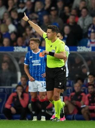 Referee Marian Barbu with red card in his hand after sending off Cameron Devlin of Rangers, in background. Rangers v Jablonec, UEFA Conference League, Play-Off Round, First Leg, Football, Ibrox Stadium, Glasgow, Scotland, UK - 20 Aug 2026Glasgow Ibrox Stadium Scotland United Kingdom  Copyright: xStuartxWallace Shutterstockx 17108686bt