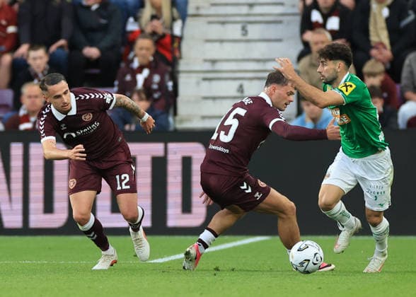 Heart of Midlothian v SK Rapid Wien UEFA Europa Conference League Tom Renaud of Heart of Midlothian (left) and Josh McPake of Heart of Midlothian (middle) defends against Yusuf Demir of SK Rapid Wien (right) during the UEFA Europa Conference League Play-Off First Leg match at Tynecastle Park, Edinburgh 20 08 2026 UK Newspapers OUT Copyright: xFredxPalmerx FIL-23809-0179
