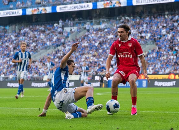 Pablo Rodriguez of KKS Lech Poznan slide tackles during UEFA Europa League - Playoff Round season 26 27 match between teams of KKS Lech Poznan and FC Thun (Ruslan Taran Ball Raw Images) Poznan Enea Stadium Poland Copyright: xRuslanxTaranx _IMG1387