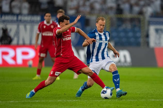 Gustav Berggren of KKS Lech Poznan tackles during UEFA Europa League - Playoff Round season 26 27 match between teams of KKS Lech Poznan and FC Thun (Ruslan Taran Ball Raw Images) Poznan Enea Stadium Poland Copyright: xRuslanxTaranx _IMG7517