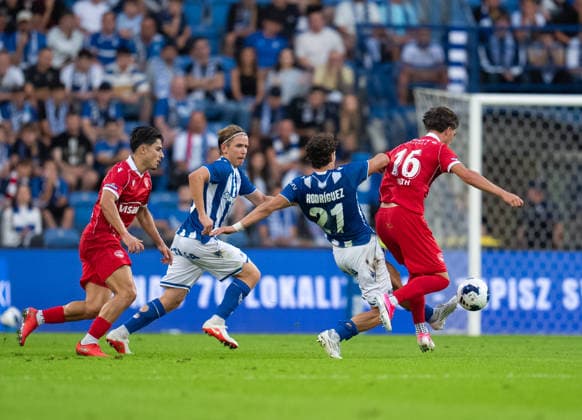 Pablo Rodriguez of KKS Lech Poznan tackles against Justin Roth of FC Thun during UEFA Europa League - Playoff Round season 26 27 match between teams of KKS Lech Poznan and FC Thun (Ruslan Taran Ball Raw Images) Poznan Enea Stadium Poland Copyright: xRuslanxTaranx _IMG4936