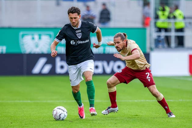 2026.08.21, xkwix, Fußball, DFB-Pokal, Preußen Münster - Karlsruher SC, LVM-Preußenstadion, 1.Runde, Saison 2026 2027: Charalambos Makridis (Preussen Muenster 14) im Zweikampf gegen Sebastian Jung (Karlsruher SC 2) DFB regulations prohibit any use of photographs as image sequences and or quasi-video. Photo: xKamilxWilkowskixPressefotoKochx Nordrhein-Westfalen Deutschland *** August 21, 2026, xkwix, Soccer, DFB Cup, Preußen Münster vs. Karlsruher SC, LVM Preußenstadion, Round 1, 2026–2027 Season: Charalambos Makridis of Preußen Münster (No. 14) in a tackle against Sebastian Jung of Karlsruher SC (No. 2). DFB regulations prohibit any use of photographs as image sequences and or quasi-video. Photo: xKamilxWilkowskixPressefotoKochx, North Rhine-Westphalia, Germany
