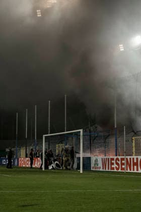 21.08.2026, xhettx, Fussball DFB Pokal 1.Runde, SV Waldhof Mannheim - 1.FC Kaiserslautern v.l. Lauternfans legen ein Feuer im Gästeblock (DFL DFB REGULATIONS PROHIBIT ANY USE OF PHOTOGRAPHS as IMAGE SEQUENCES and or QUASI-VIDEO) *** August 21, 2026, xhettx, Soccer DFB Cup First Round, SV Waldhof Mannheim 1, FC Kaiserslautern; Lautern fans set a fire in the visitors section. DFL and DFB regulations prohibit any use of photographs as image sequences and or quasi-video.
