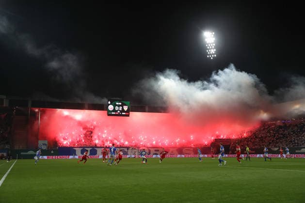 21.08.2026, xtgx, Fussball DFB-Pokal 1. Runde, FC Hansa Rostock - VfB Stuttgart, v.l. Symbolfoto, Symbolbild, Symbol Fans, Zuschauer, Publikum, Tribuene Pyro, Pyrotechnik, Bengalo, Rauch, Feuerwerk (DFL DFB REGULATIONS PROHIBIT ANY USE OF PHOTOGRAPHS as IMAGE SEQUENCES and or QUASI-VIDEO) Rostock *** August 21, 2026, xtgx, Soccer DFB Cup 1st Round, FC Hansa Rostock vs. VfB Stuttgart, from left: stock photo, stock image, stock photo of fans, spectators, audience, stands, pyrotechnics, pyrotechnics, flares, smoke, fireworks. DFL and DFB regulations prohibit any use of photographs as image sequences and or quasi-video. Rostock