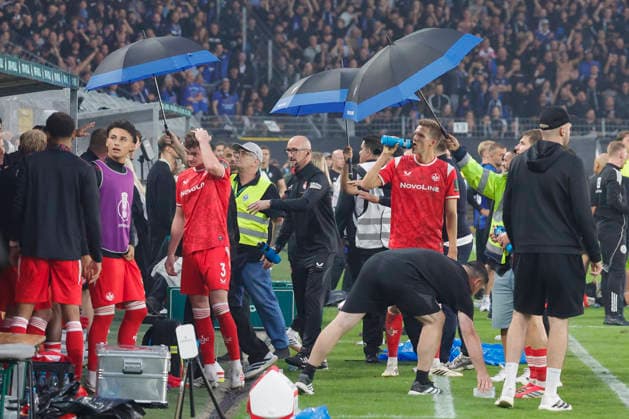 Im Bild: Fans bewerfen die Spieler vom 1. FC Kaiserslautern mit Baechern. Regenschirme mussten ausgeklappt werden. 21.08.2026, SV Waldhof Mannheim 07 - 1. FC Kaiserslautern, DFB-Pokal, 1. Runde, Deutschland, Mannheim, Carl-Benz-Stadion, DFL REGULATIONS PROHIBIT ANY USE OF PHOTOGRAPHS AS IMAGE SEQUENCES AND OR QUASI-VIDEO. *** In the photo, fans are throwing bottles at the 1 FC Kaiserslautern players; umbrellas had to be opened. August 21, 2026, SV Waldhof Mannheim 07 vs. 1 FC Kaiserslautern, DFB Cup, First Round, Germany, Mannheim, Carl Benz Stadium, DFL regulations prohibit any use of photographs as image sequences and or quasi-video Copyright: HMBxMedia xJulienxBecker
