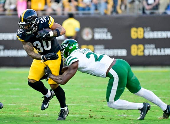 Pittsburgh Steelers running back Jaylen Warren (30) gains gains six yard as New York Jets cornerback Brandon Stephens (21) makes the tackle during the second quarter at Acrisure Stadium on Thursday, Friday, Aug. 21, 2026 in Pittsburgh.  PIT2026082106 ARCHIExCARPENTER