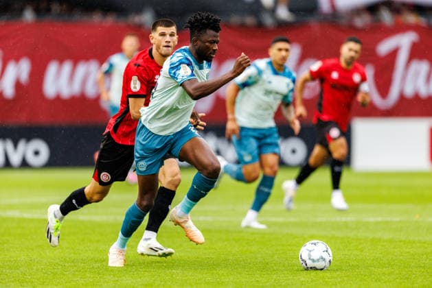 WIESBADEN, GERMANY - AUGUST 22: Edmond Tapsoba (Bayer 04 Leverkusen, 12) is challenged by Moritz Flotho (SV Wehen Wiesbaden, 28) during the first-round match between SV Wehen Wiesbaden vs. Bayer 04 Leverkusen at Brita Arena of the German Cup on August 22, 2026 in Wiesbaden, Germany. DFL REGULATIONS PROHIBIT ANY USE OF PHOTOGRAPHS AS IMAGE SEQUENCES AND OR QUASI-VIDEO. Hessen Germany Copyright: xStephanxHahnex