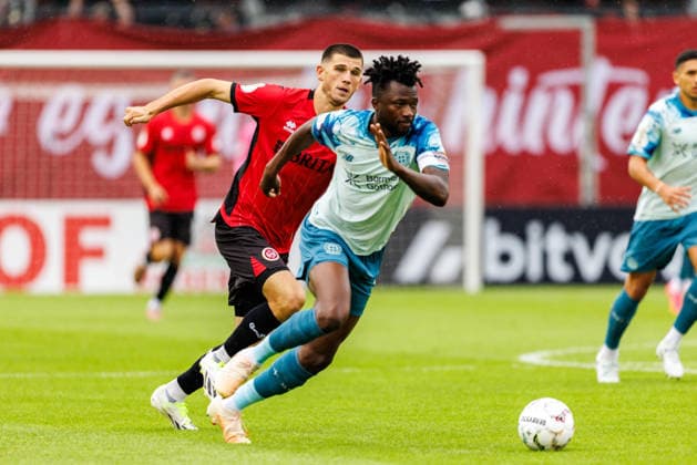 WIESBADEN, GERMANY - AUGUST 22: Edmond Tapsoba (Bayer 04 Leverkusen, 12) is challenged by Moritz Flotho (SV Wehen Wiesbaden, 28) during the first-round match between SV Wehen Wiesbaden vs. Bayer 04 Leverkusen at Brita Arena of the German Cup on August 22, 2026 in Wiesbaden, Germany. DFL REGULATIONS PROHIBIT ANY USE OF PHOTOGRAPHS AS IMAGE SEQUENCES AND OR QUASI-VIDEO. Hessen Germany Copyright: xStephanxHahnex