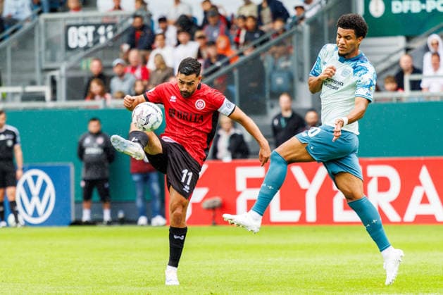 WIESBADEN, GERMANY - AUGUST 22: Tarik Goezuesirin (Gözüsirin, SV Wehen Wiesbaden, 11) is challenged by Malik Tillman (Bayer 04 Leverkusen, 10) during the first-round match between SV Wehen Wiesbaden vs. Bayer 04 Leverkusen at Brita Arena of the German Cup on August 22, 2026 in Wiesbaden, Germany. DFL REGULATIONS PROHIBIT ANY USE OF PHOTOGRAPHS AS IMAGE SEQUENCES AND OR QUASI-VIDEO. Hessen Germany Copyright: xStephanxHahnex