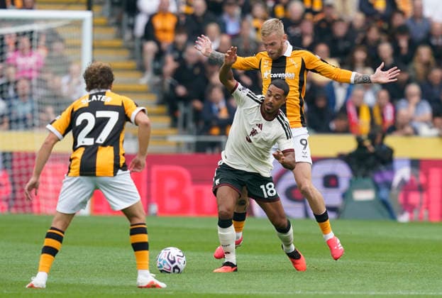 Kingston upon Hull, England, 22nd August 2026. Youri Tielemans of Manchester United, ManU (C) is challenged by Oli McBurnie of Hull City (R) and Regan Slater of Hull City during the Hull City vs Manchester United Premier League match at the MKM Stadium, Kingston upon Hull. Picture credit should read: Andrew Yates Sportimage EDITORIAL USE ONLY. No use with unauthorised audio, video, data, fixture lists, club league logos or live services. Online in-match use limited to 120 images, no video emulation. No use in betting, games or single club league player publications. SPI_012_AY_HULL_MAN_UTD SPI-4925-0010