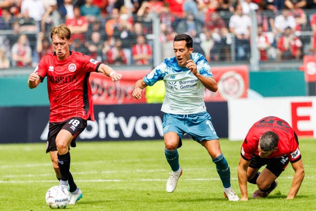 WIESBADEN, GERMANY - AUGUST 22: Fabian Greilinger (SV Wehen Wiesbaden, 18) and Lucas Vazquez (Bayer 04 Leverkusen, 17) compete for the ball during the first-round match between SV Wehen Wiesbaden vs. Bayer 04 Leverkusen at Brita Arena of the German Cup on August 22, 2026 in Wiesbaden, Germany. DFL REGULATIONS PROHIBIT ANY USE OF PHOTOGRAPHS AS IMAGE SEQUENCES AND OR QUASI-VIDEO. Hessen Germany Copyright: xStephanxHahnex