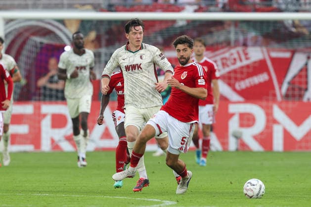 22.08.2026, xtgx, Fussball - DFB Pokal 1.Runde Energie Cottbus - FC Augsburg emspor, v.l. Christian Matsima (Augsburg, 5) am Ball, plays the ball (DFL DFB REGULATIONS PROHIBIT ANY USE OF PHOTOGRAPHS as IMAGE SEQUENCES and or QUASI-VIDEO) Cottbus *** August 22, 2026, xtgx, Soccer, DFB Cup, First Round: Energie Cottbus vs. FC Augsburg, emspor; from left: Christian Matsima (Augsburg), 5 on the ball, plays the ball. DFL and DFB regulations prohibit any use of photographs as image sequences and or quasi-video. Cottbus