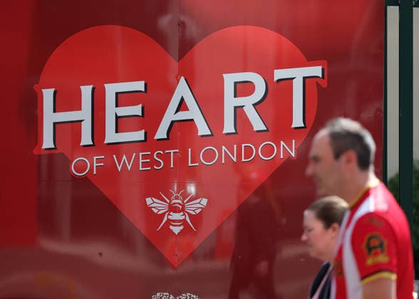 RECORD DATE NOT STATED 22nd August 2026; Gtech Community Stadium, Brentford, London, England; Premier League Football, Brentford versus Tottenham Hotspur; Brentford fans walking past Heart of West London sign outside Gtech Community Stadium JohnxPatrickxFletcher