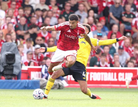 Morgan Gibbs-White (NF) Ethan Ampadu (LU) at the Nottingham Forest v Leeds United, EPL match, at The City Ground, Nottingham, Notts., on 22nd August, 2026.  .
